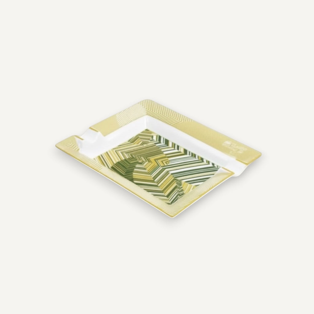 Arcadia Cigars Davidoff Cave de Paille ashtray, golden-beige straw marquetry with green abstract pattern on lacquered base.