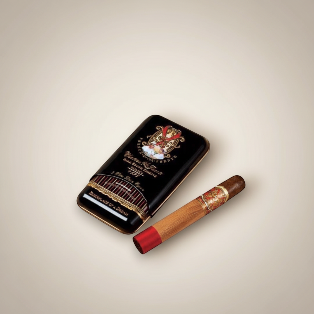 Arcadia Cigars Arturo Fuente Opus X Perfecxion X cigar with red band and gold accents, next to its black tin.