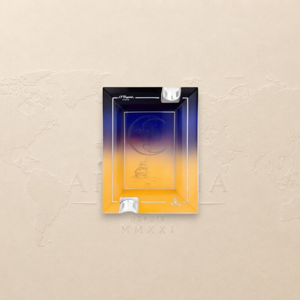 Arcadia Cigars S.T. Dupont Montecristo L' Aurore porcelain ashtray with sunrise motif, pink and gold tones, two rests.