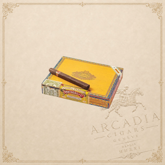 Arcadia Cigars Partagas Churchills De Luxe cigar resting on its yellow wooden box against a neutral background.