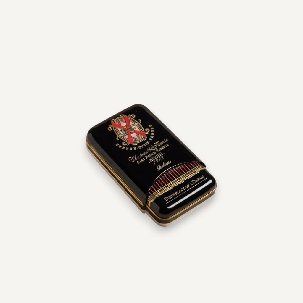 Arcadia Cigars Arturo Fuente Opus X Robusto cigar tin, black with gold lettering and red accents.