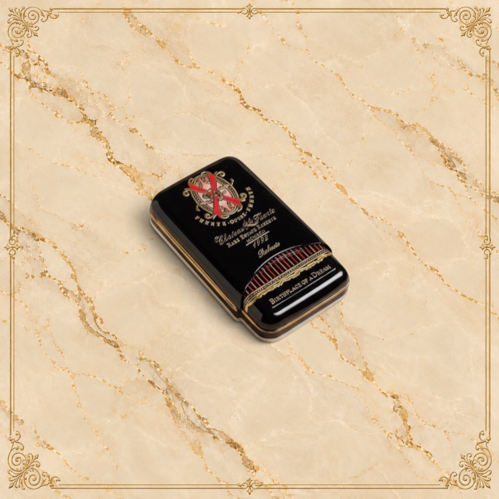 Arcadia Cigars Arturo Fuente Opus X Robusto cigar tin, black with gold lettering and red accents.