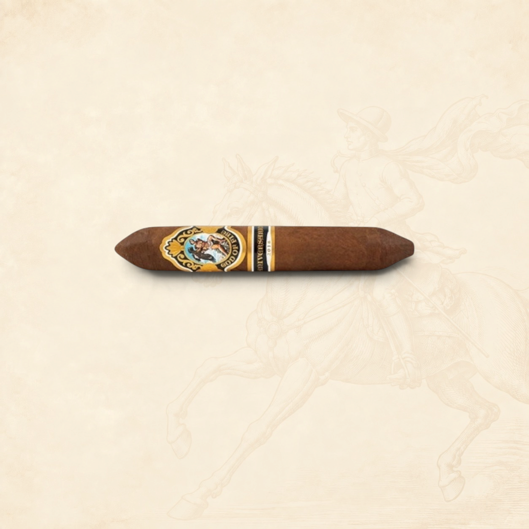 Arcadia Cigars God of Fire Serie Aniversario 60 cigar with ornate gold and black band on a textured cream background.