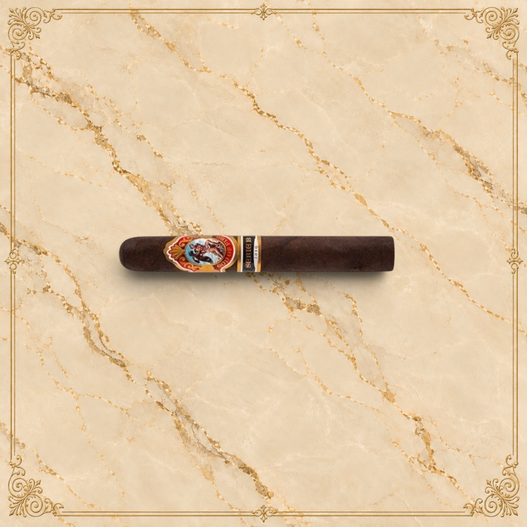 Arcadia Cigars God of Fire Serie B Gran Toro premium cigar with ornate band on a cream background