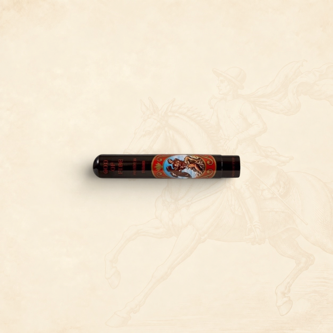Arcadia Cigars God of Fire Serie B Robusto cigar in a protective black tubo with ornate decorative branding
