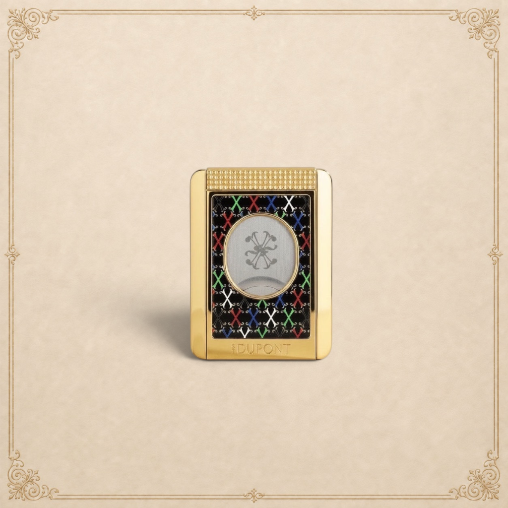 Arcadia Cigars S.T. Dupont gold cigar cutter with black face, red, white, green, blue X pattern, and textured grip.