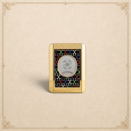 Arcadia Cigars S.T. Dupont gold cigar cutter with black face, red, white, green, blue X pattern, and textured grip.