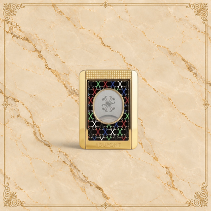 Arcadia Cigars S.T. Dupont gold cigar cutter with black face, red, white, green, blue X pattern, and textured grip.