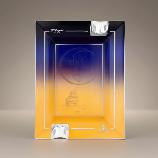 Arcadia Cigars S.T. Dupont Montecristo L' Aurore porcelain ashtray with sunrise motif, pink and gold tones, two rests.