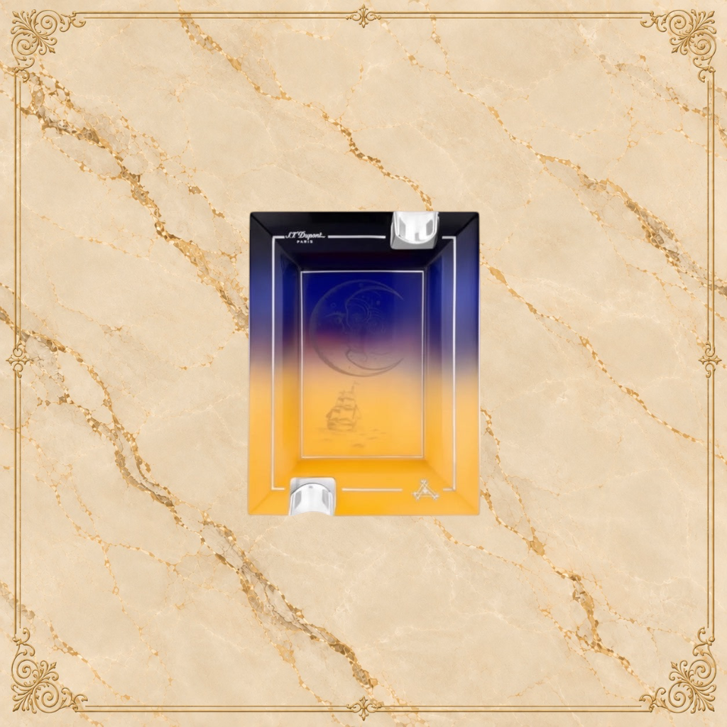 Arcadia Cigars S.T. Dupont Montecristo L' Aurore porcelain ashtray with sunrise motif, pink and gold tones, two rests.